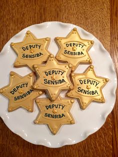 some cookies that are on a white plate with words written on them in different languages