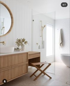 a bathroom with a sink, mirror and stool