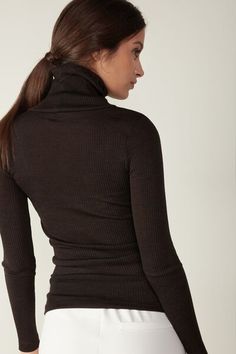 Long-sleeve high-neck tubular top made from a wool-silk blend. Fitted Merino Wool Turtleneck For Fall, Elegant Fitted Turtleneck For Winter, Elegant Fitted Winter Turtleneck, Elegant Winter Fitted Turtleneck, Fitted Merino Wool Turtleneck For Layering, High Neck Merino Wool Tops For Fall, Merino Wool Turtleneck Top For Work, Fitted Merino Wool Tops For Layering, Fitted Turtleneck For Fall