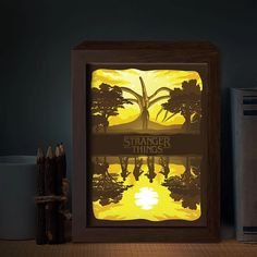 a shadow box with a sunset scene in it