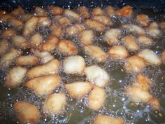 some food is cooking in a pan with water on the stove top and it looks like they have been fried