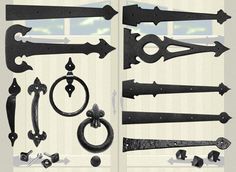 an assortment of black iron door handles and knobs on a white striped wallpapered background