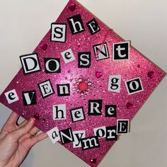 a pink graduation cap with words that spell out she doesn't even go there anymore