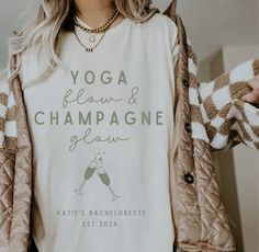 a woman wearing a t - shirt that says yoga, flour and champagne below her