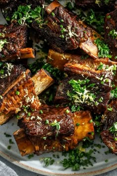 a white plate topped with meat covered in parsley