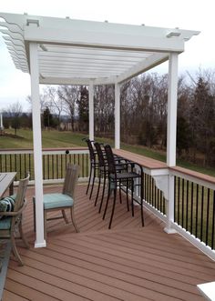 a wooden deck with chairs and tables on it