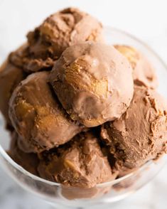 three scoops of ice cream in a glass bowl