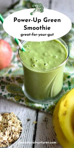 a green smoothie in a glass next to bananas and oatmeal on a table