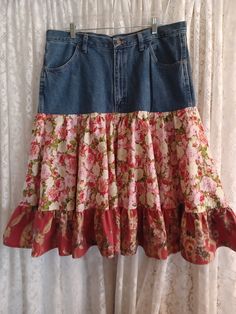 a skirt hanging on a curtain with floral print and ruffled hems in front