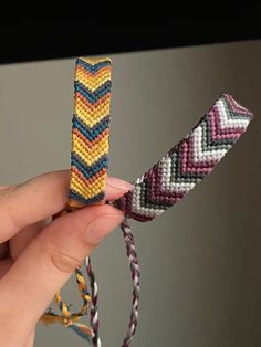 a person holding two different colored bracelets