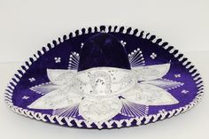 A piece of Mexico for every occasion! Add a touch of Mexican flair to your celebrations with our unique Sombrero del Charro! Made from fine velvet fabric and decorated with decorative ribbons in shimmering gold or silver, this exclusive hat will attract everyone's attention. The shiny sequins add an extra dose of glamour and make it the perfect accessory for Halloween, Mardi Gras or any other family or business celebration, or a colorful decoration on the wall instead of a picture. Thanks to its Mariachi Hat, Mexican Sombrero, Costume Hats, Plum Purple, Color Combination, Colorful Decor, Velvet Fabric, Mardi Gras, Costume Accessories