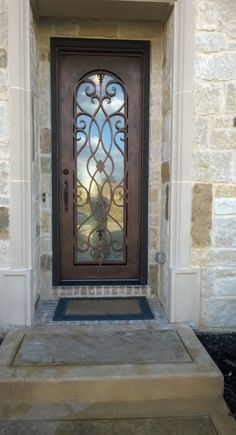 the front door to a house with a decorative glass design on it's side