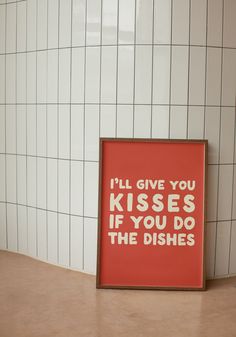 a red framed poster with the words i'll give you kisses if you do the dishes