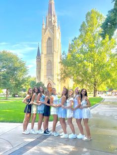 four girls standing in front of a church