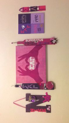 some skis and snowboards are hanging on the wall with tags attached to them