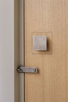 a close up of a wooden door with a metal handle on the front and side