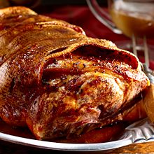 roast pork shoulder on a plate with parsley