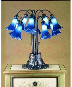 a table lamp with blue glass shades on it