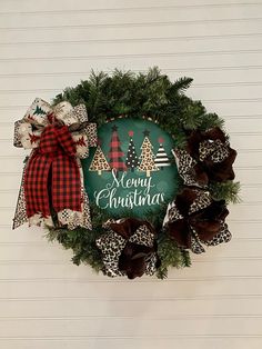 a merry christmas wreath hanging on the wall