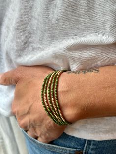 Made from speckled hunter-green Czech glass seed beads on strong elastic cording, these bracelets wrap around your wrist five times and feature strips of metallic gold Czech beads for a touch of class. These Boho beaded wrap bracelets come in a wide variety of colors, with options for metallic silver strips instead of gold. Or wear it twice around the neck as a necklace for a lively, free-spirited summer style. SIZE: Approx. 6.5 inches around Silver Sprinkles, Gold Sprinkles, Boho Wrap Bracelet, Color Vibe, Jewelry Accessories Ideas, Beaded Wrap Bracelets, Wrap Bracelets, Beaded Wraps, Seed Bead Bracelets