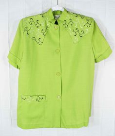 "This one is just fascinating. I'm pretty sure this is from the 1940s, could be early 50s?  Vintage Dana Meadors Women's Short Sleeve Button Shirt w/ Shoulder Pads, Green w/ Embroidered Half Western Yoke, Size 22.5\" P2P I wasn't able to find anything online about this brand. The pinked inside cloth edges points to 50s vintage according to some online sources. This flares out from the underarm down to the bottom button. The single front pocket makes it house dress like. Near mint condition. Just Retro Short Sleeve Shirt With Button Closure, Retro Spread Collar Top With Button Closure, Retro Collared Embroidered Top, Retro Embroidered Collared Top, Retro Button-up Blouse With Button Closure, Western Button-up Tops With Pockets, Vintage Button-up Tops With Snap Buttons, 50s Vintage, House Dress