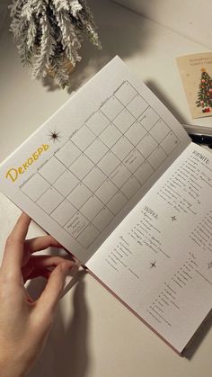 a person is holding an open christmas calendar