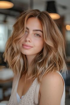 Smiling woman with wavy, shoulder-length hair in a softly lit indoor setting. From Blonde To Caramel Hair, Caramel Balayage On Red Hair, Fall Hair For Fair Skin Brown Eyes, Blond To Brown Balayage, Light Brown Hair Ginger Highlights, Autumn Caramel Hair, Caramel Medium Length Hair, Dark Autumn Hair Color Blonde, Hair Color For Light Skin Brown Eyes