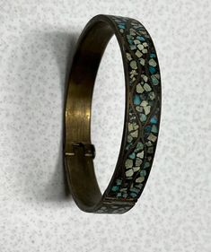 Vintage Turquoise Inlayed Bangle Bracelet Brass  Gorgeous vintage antique has no makers marks that I can see. Clasp is in great working condition. Piece has a  3"circumference and 1/2"width Needs to be cleaned will leave up to buyer. Lovely turquoise stones with tarnished brass finish perfect for boho western country farmhouse Victorian dark academia gothic style. Most items we sell are preowned and loved and sold as is. We do our best to describe each item as it is found. Please review all photos. We gladly bundle anything we list and here are a few things we offer! All items will be packed with care. MCM Retro Academia Ephemera  Country cottage Cottage core Romantic cottage Romantic farmhouse Farmhouse decor Country farmhouse Country decor Vintage Turquoise Bangle Cuff Bracelet, Turquoise Patina Bracelet Jewelry, Turquoise Patina Bracelet, Antique Turquoise Adjustable Bracelet, Vintage Turquoise Bracelet With Inlay, Antique Turquoise Bangle Cuff Bracelet, Vintage Turquoise Bracelets With Inlay, Vintage Brass Jewelry With Turquoise, Vintage Turquoise Brass Jewelry