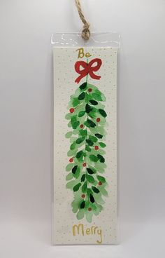 a christmas card hanging from a string