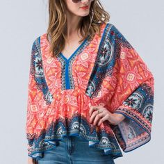 Poly Spandex Blend The Print And Shape On This Top Will Flatter All Body Types Blue Vibrant Print V-neck Top, Multicolor Stretch Tops For Vacation, Bohemian Stretch Top With Floral Print, Bohemian Stretch Tops For Vacation, Stretch Patterned Beach Tops, Vibrant Red V-neck Top, Spring Top With Vibrant Print And Stretch, Blue Boho Print V-neck Top, Spring Tops With Vibrant Print And Stretch