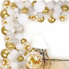 white and gold balloons are hanging from the ceiling