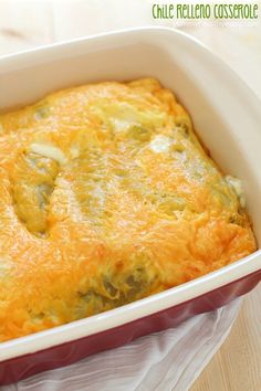 a casserole dish with cheese and broccoli in it on a table