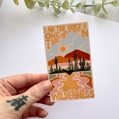 someone holding up a sticker with the words i am the voice in the wilderness