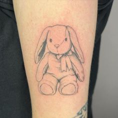 a small tattoo of a rabbit on the arm