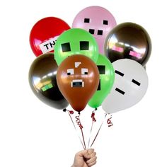 a bunch of balloons that have faces on them