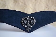 Vintage 80s blue suede leather belt with an aged silver metal heart decoration with flowers in it, set in the center of the belt. The belt closes at the back.  Material - It has two layers:  top is blue suede, underneath is vinyl Size - 95 cm which is 37.4 inches Approximate Measurements: from from the hook to the first hole (doesn't include the buckle itself)  - 36.2 inches ( 92 cm), to the last hole - 40 inches ( 101.5 cm) Width of the leather strap at its widest - 3.1 inch / 8cm Condition: Ve Boho Belt, Boho Belts, Metal Heart, Heart Decorations, Suspender Belt, Blue Suede, Cottage Core, Leather Belt, Suede Leather