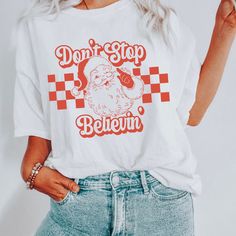 a woman wearing a white t - shirt that says don't stop belevin