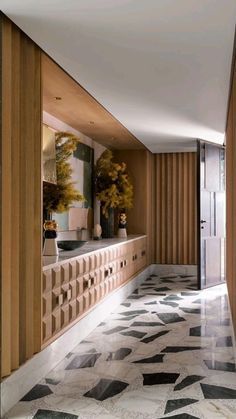 the hallway is lined with marble and wood