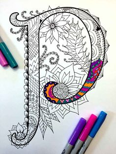 the letter q is made up of intricate designs and colorful pens on top of it