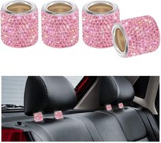 three pink glitter car seat covers and one is in the back with two cup holders