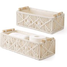 two white baskets with bamboo handles are shown on a white background and one is empty