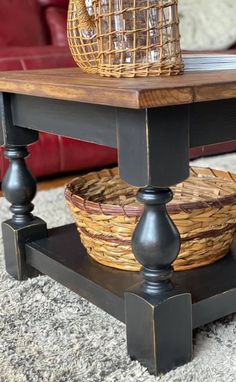 a basket sitting on top of a wooden table next to a red couch in a living room