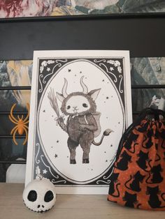 there is a card with an image of a cat on it next to a skull