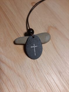 Hand carved Christian Cross on stone necklace with silver enamel inlay. Leather cord is 1m long, 1.5mm thick and tied into a sliding knot necklace. Pendant is attached to the cord by a copper plated hoop. Includes a black velvet pouch. Pieces are unique and may slightly differ in colour and size, as is the nature with hand carved natural stones :) Thanks! Adjustable Etched Symbolic Necklace, Adjustable Symbolic Etched Necklace, Spiritual Cross Jewelry With Adjustable Cord, Adjustable Round Pendant Waxed Cord Jewelry, Symbolic Adjustable Etched Necklaces, Adjustable Cross Pendant Jewelry, Symbolic Adjustable Etched Necklace, Symbolic Etched Adjustable Necklace, Artisan Etched Adjustable Necklace