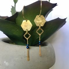 These pretties have been hammered with love! Every piece of raw brass on these unique earrings have been hammered & texturized to make them glimmer & glow! Hexagons & squares give these a geometric modern design. Nickel free & so comfortable. Blue Hammered Drop Earrings, Nickel Free Gold Hexagon Jewelry, Blue Hammered Dangle Jewelry, Blue Hammered Earrings For Gift, Blue Bohemian Hammered Earrings, Bohemian Blue Hammered Earrings, Gold Faceted Brass Earrings, Blue Hammered Artisan Jewelry, Artisan Blue Hammered Jewelry