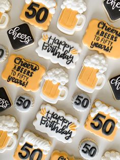 birthday cookies decorated with frosting and icing are arranged in the shape of beer mugs