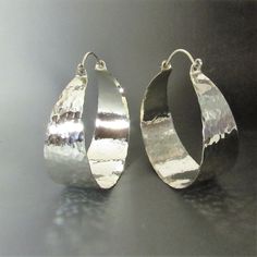 "Dazzling they are with their mirror shiny hammered finish, extra large hammered argentium sterling silver hoop earrings. With apx. 1300 hammer strikes to give this pair its wonderful finish and painstakingly polished to a brilliance this is the pair that you wear when you definitely want to be noticed. Although we've never used the word bling to describe our jewelry and we won't start today we will just say this is the pair you wear when you need some serious ZING! Argentium sterling is a tiny Chunky Silver Jewellery, Silver Statement Jewelry, Hoops Silver, African Earrings, Funky Jewelry, Jewelry Lookbook, Sterling Silver Hoop Earrings, Large Earrings, Dream Jewelry