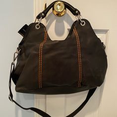 Never Worn! With Tags! In Great Condition. No Sign Of Wear Comes With Dust Bag Has Longer Strap That Is Removable Has Brown/Burnt Orange Stitching Detail Brown Rectangular Satchel With Gunmetal Hardware, Brown Rectangular Shoulder Bag With Gunmetal Hardware, Brown Top Handle Shoulder Bag With Gunmetal Hardware, Brown Tote Satchel With Gunmetal Hardware, Brown Satchel With Gunmetal Hardware For Daily Use, Brown Top Handle Hobo Travel Bag, Brown Hobo Bag With Detachable Strap For Daily Use, Brown Hobo Bag With Detachable Strap For Travel, Brown Satchel With Gunmetal Hardware For Travel