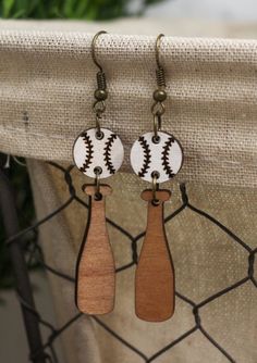 two wooden earrings with baseballs on them