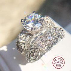 a diamond ring sitting on top of a piece of paper